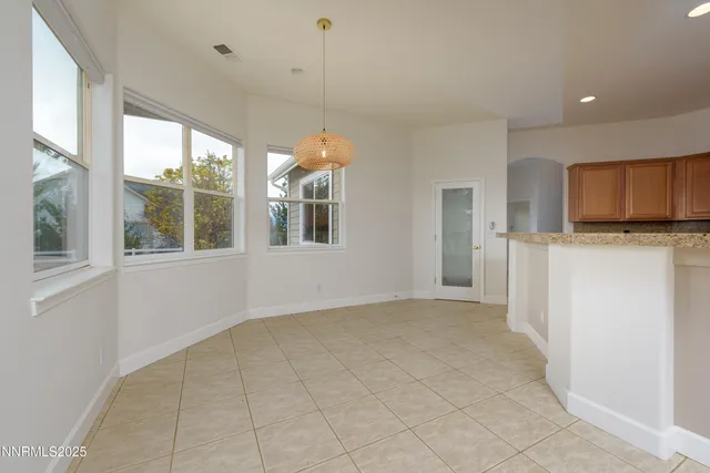 a view of a livingroom with a fireplace and window