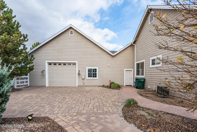 a view of a house with backyard and sitting area