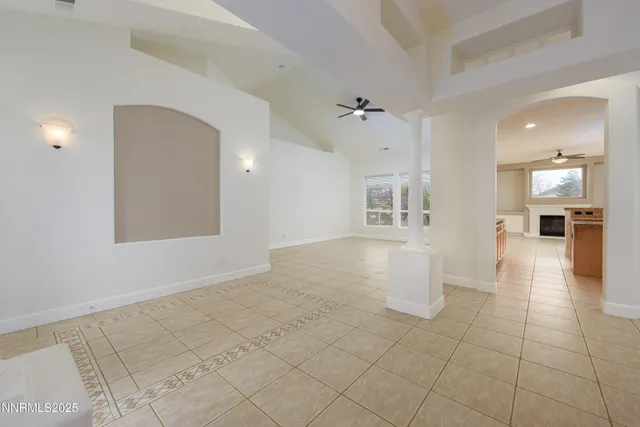 a view of a big room with wooden floor and a kitchen