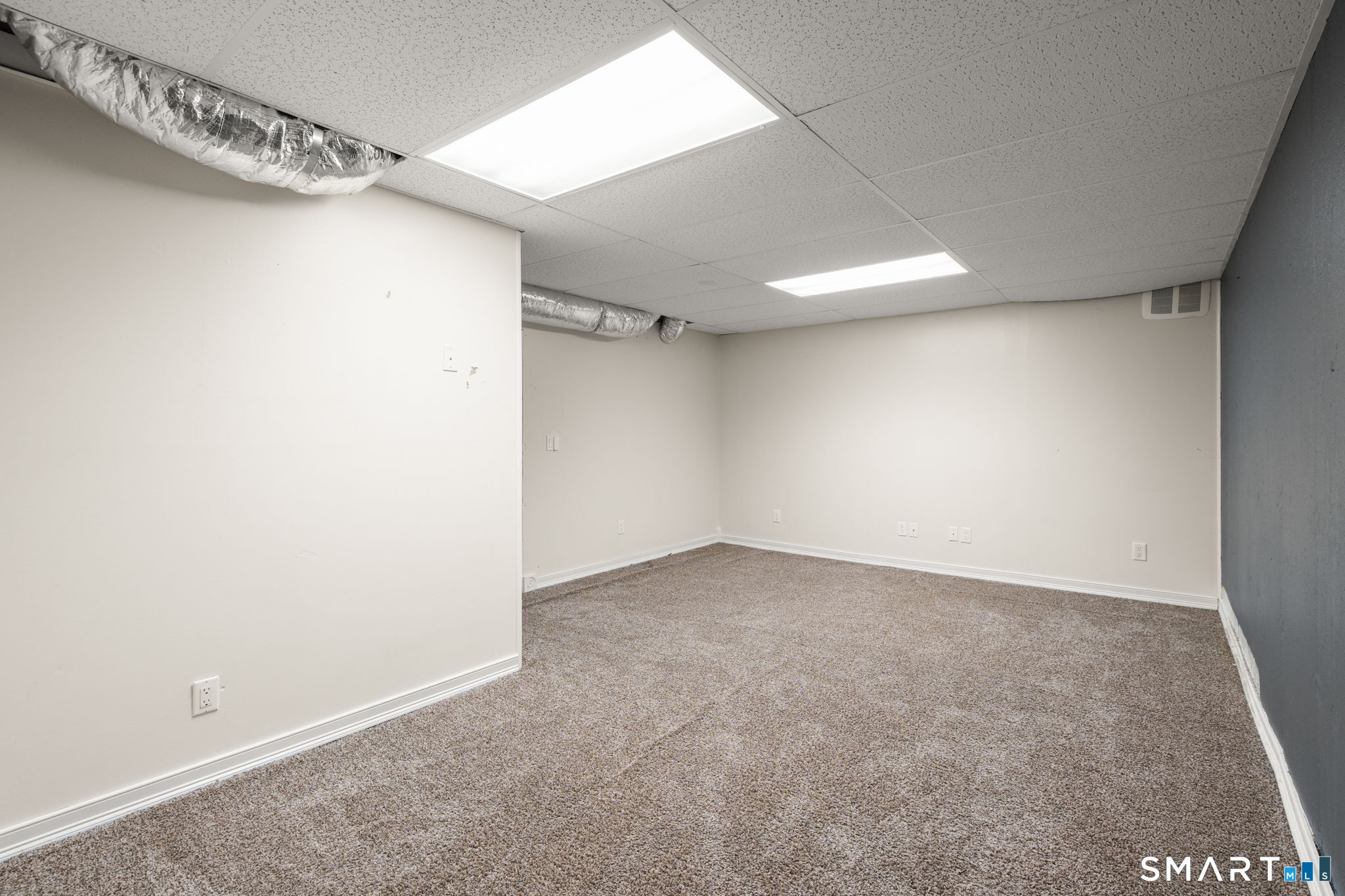 141 Briar Hill Road Groton, CT 06340 - Photo 36 of 40 Finished room in the basement, carpeted, great for an additional bedroom, office etc.