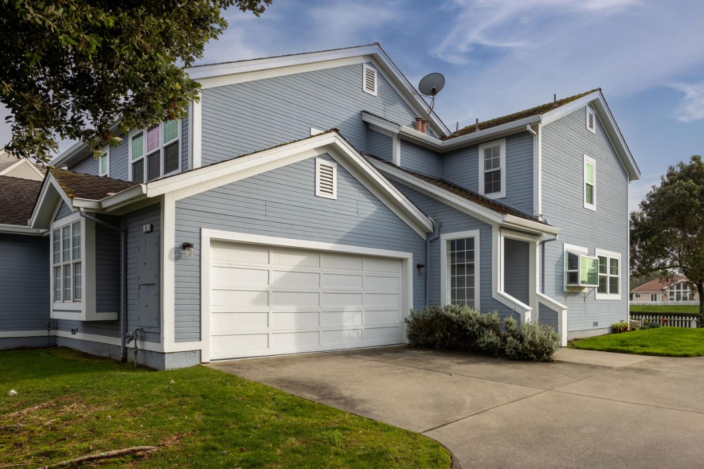 a front view of a house with a garden