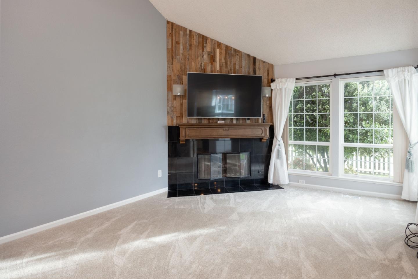 9 Merion Road Half Moon Bay, CA 94019 - Photo 3 of 14 a living room with a flat screen tv and a fireplace