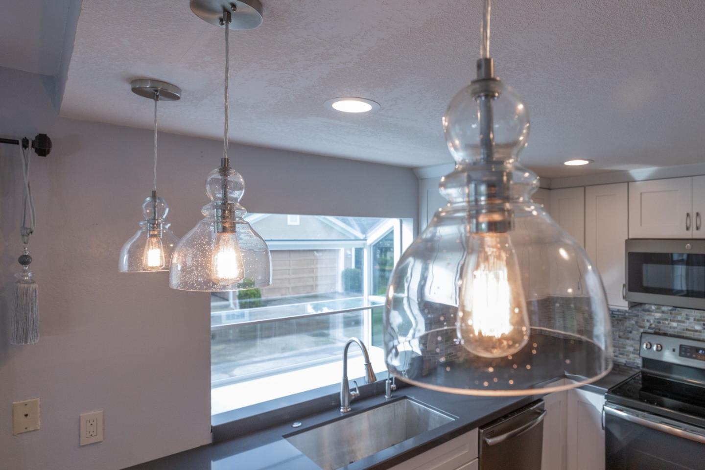 9 Merion Road Half Moon Bay, CA 94019 - Photo 7 of 14 a view of a dining hall with a dining table and chandelier
