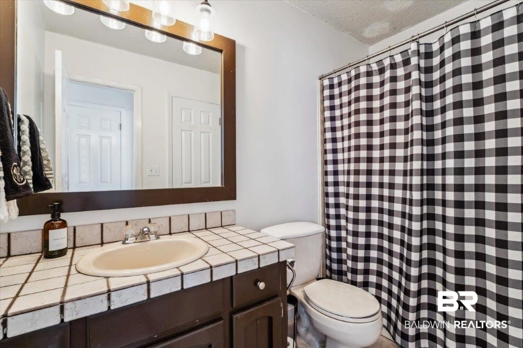 3616 Vista Ridge Drive Mobile, AL 36693 - Photo 12 of 20 Bathroom with a textured ceiling, vanity, and toilet
