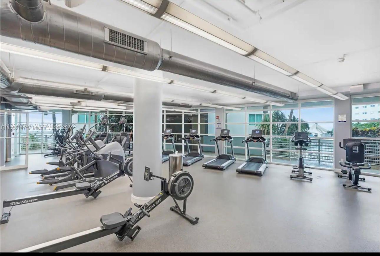 Downtown Miami Miami, FL 33132 - Photo 14 of 18 a room with gym equipment and large mirror