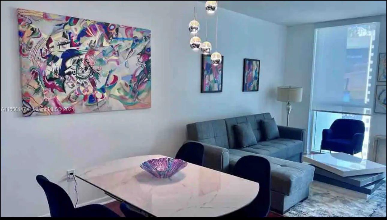 Downtown Miami Miami, FL 33132 - Photo 3 of 18 a living room with furniture and a lamp