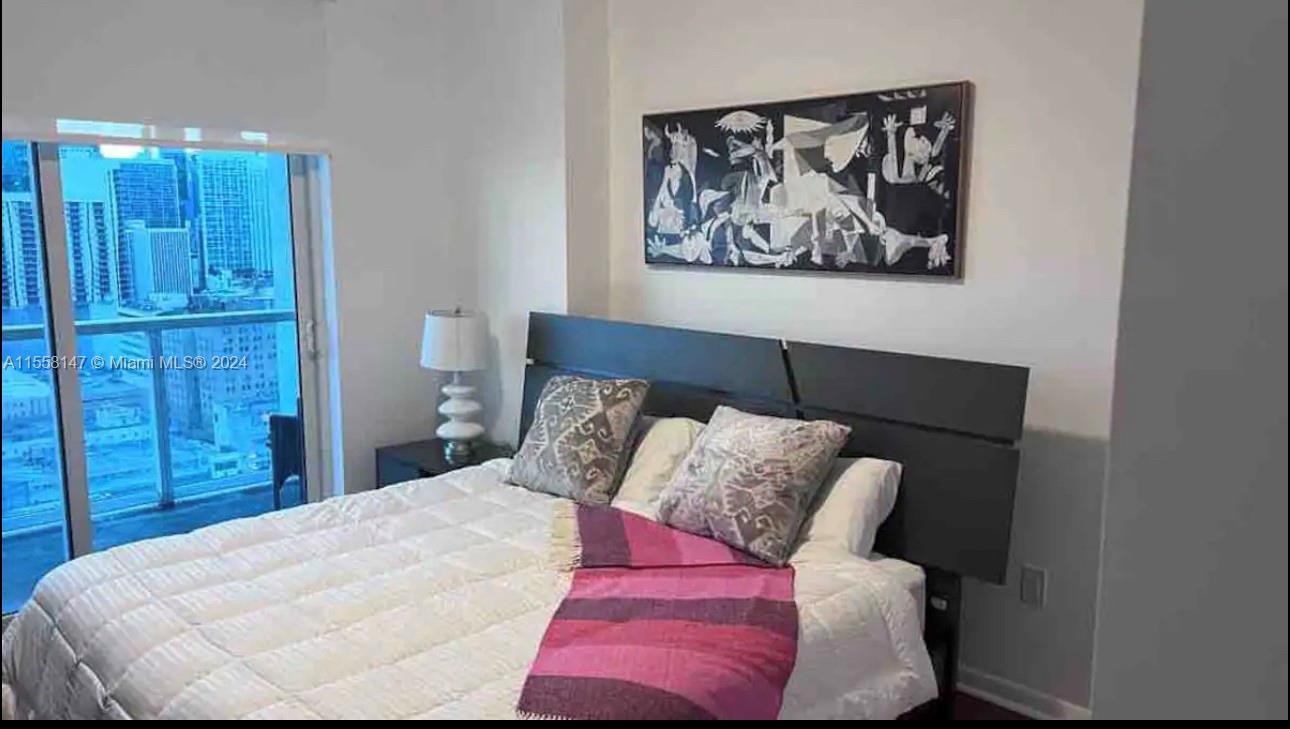 Downtown Miami Miami, FL 33132 - Photo 5 of 18 a bedroom with a bed and painting on the wall