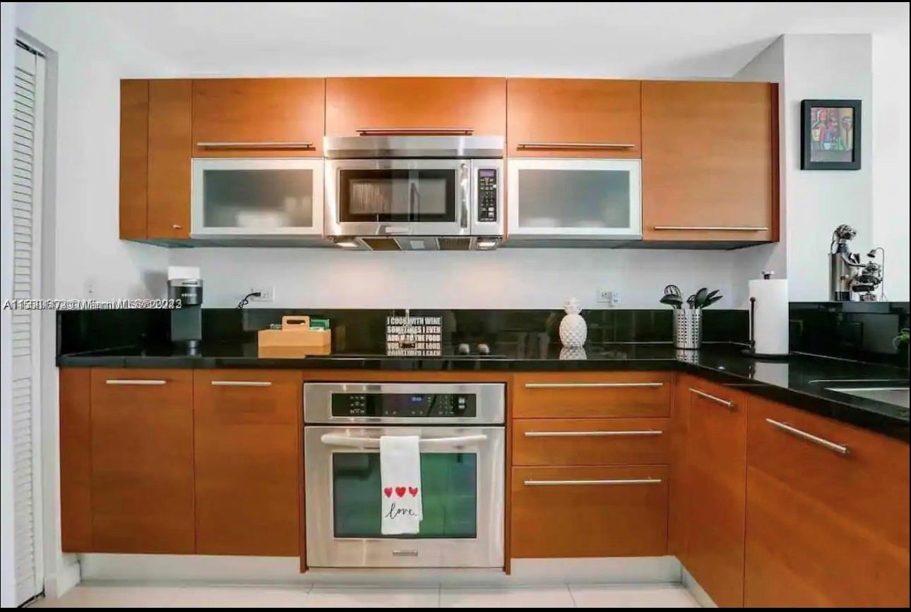 Downtown Miami Miami, FL 33132 - Photo 8 of 18 a kitchen with stainless steel appliances kitchen island granite countertop a stove top oven