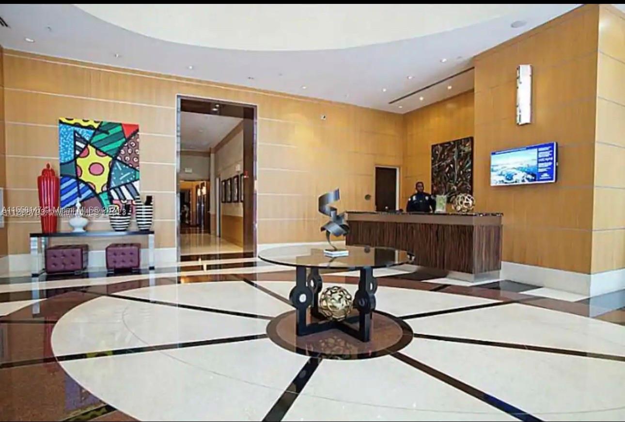 Downtown Miami Miami, FL 33132 - Photo 9 of 18 a living room with furniture and flat screen tv