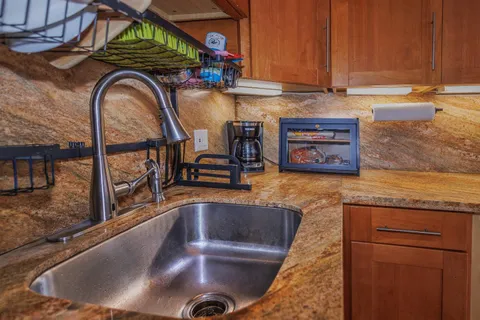 a kitchen with stainless steel appliances granite countertop a stove and a refrigerator