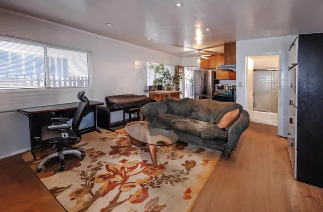 a kitchen with stainless steel appliances granite countertop a refrigerator and a stove