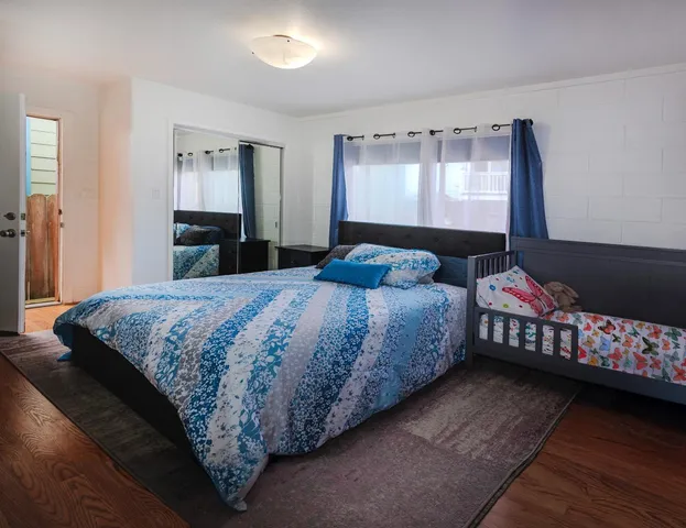 a bedroom with a bed and a dresser