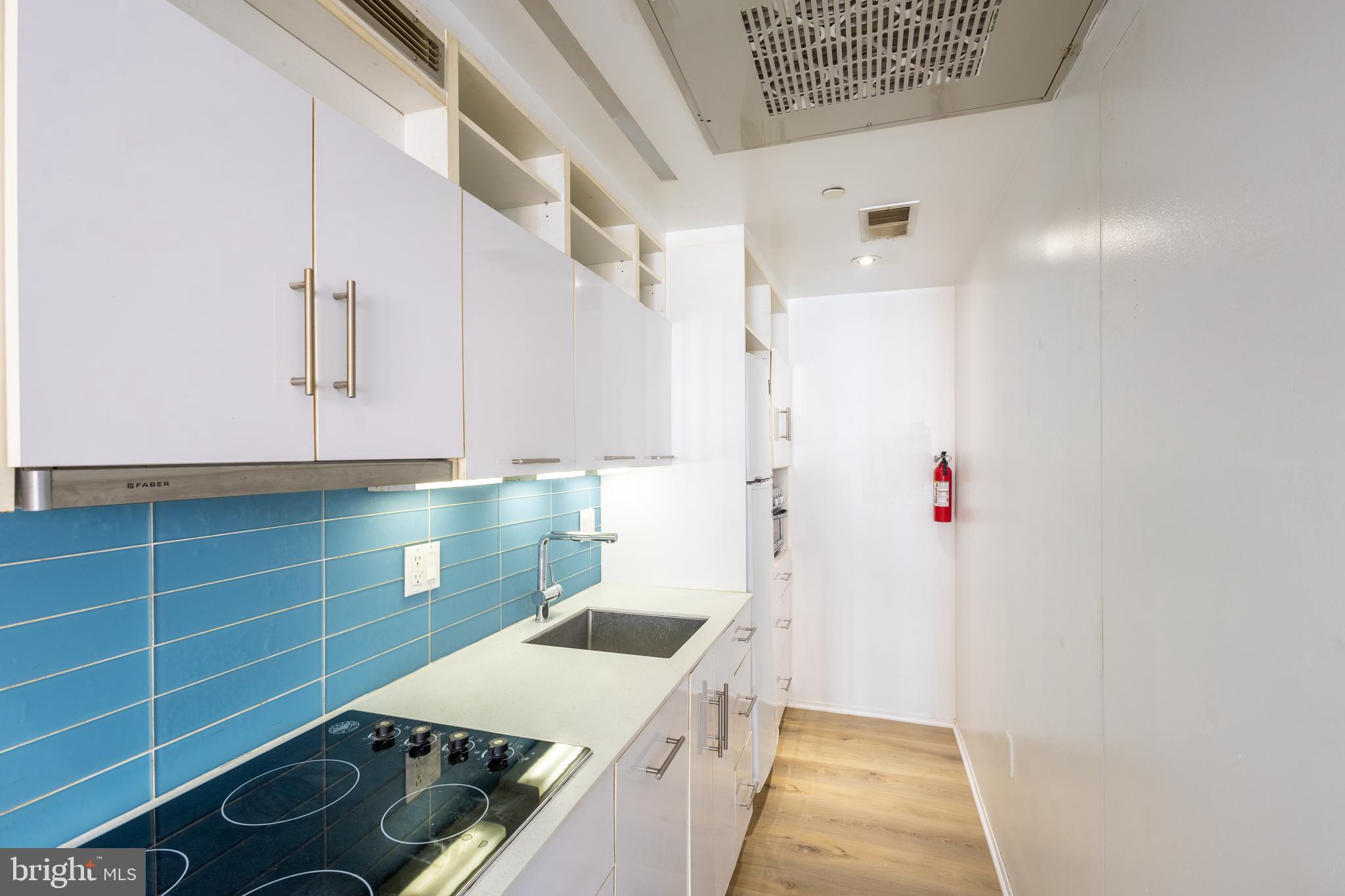 2422-2424 17th Street Northwest, Unit 201 Washington, DC 20009 - Photo 11 of 16 a kitchen with a stove and a refrigerator