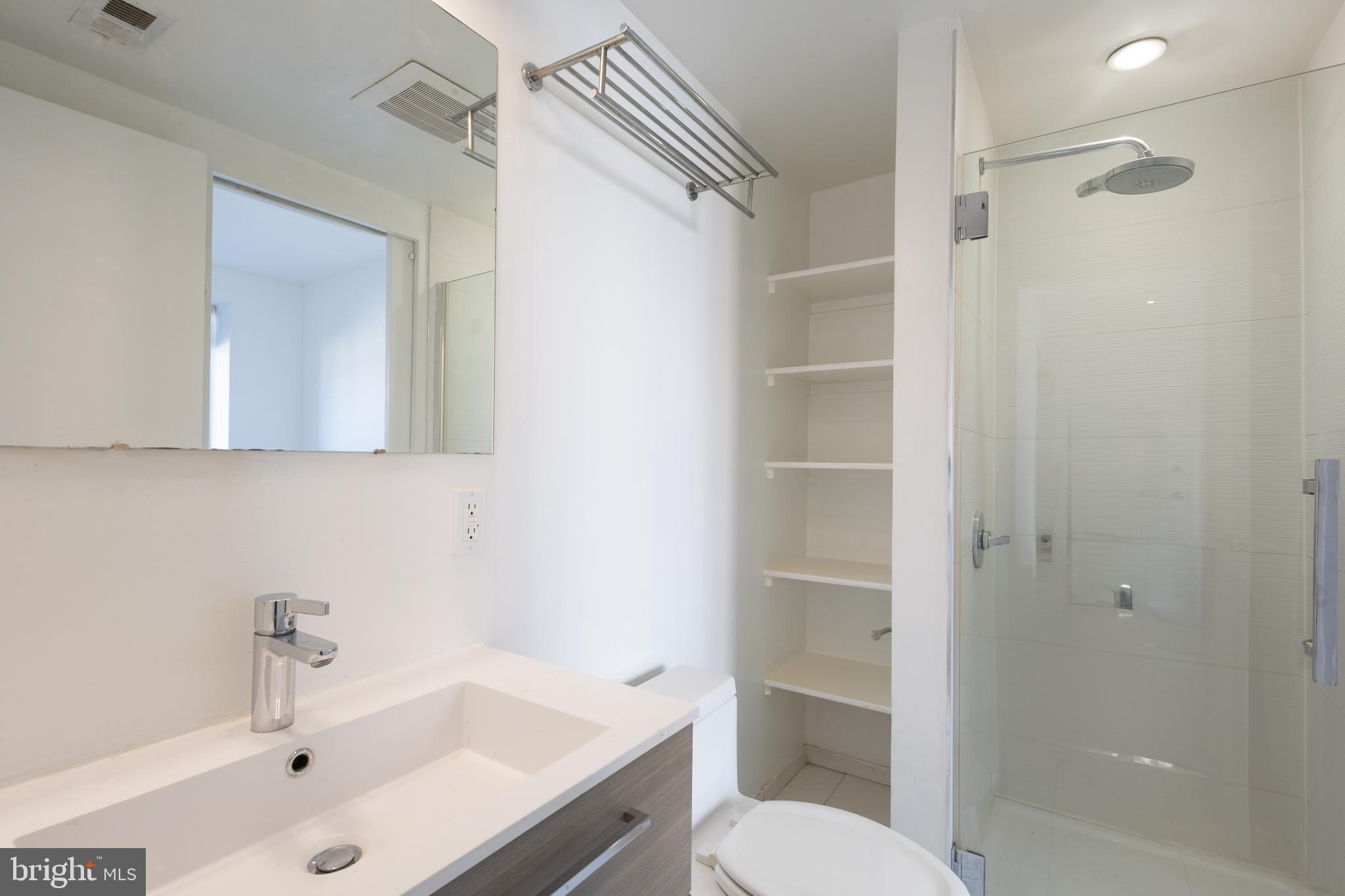 2422-2424 17th Street Northwest, Unit 201 Washington, DC 20009 - Photo 12 of 16 a bathroom with a sink a toilet and shower
