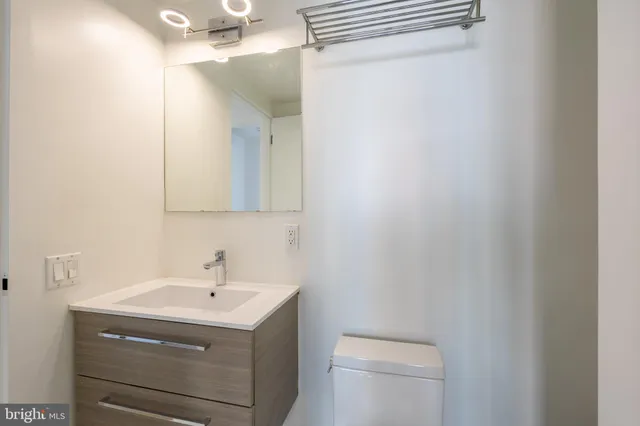 a bathroom with a sink toilet and vanity