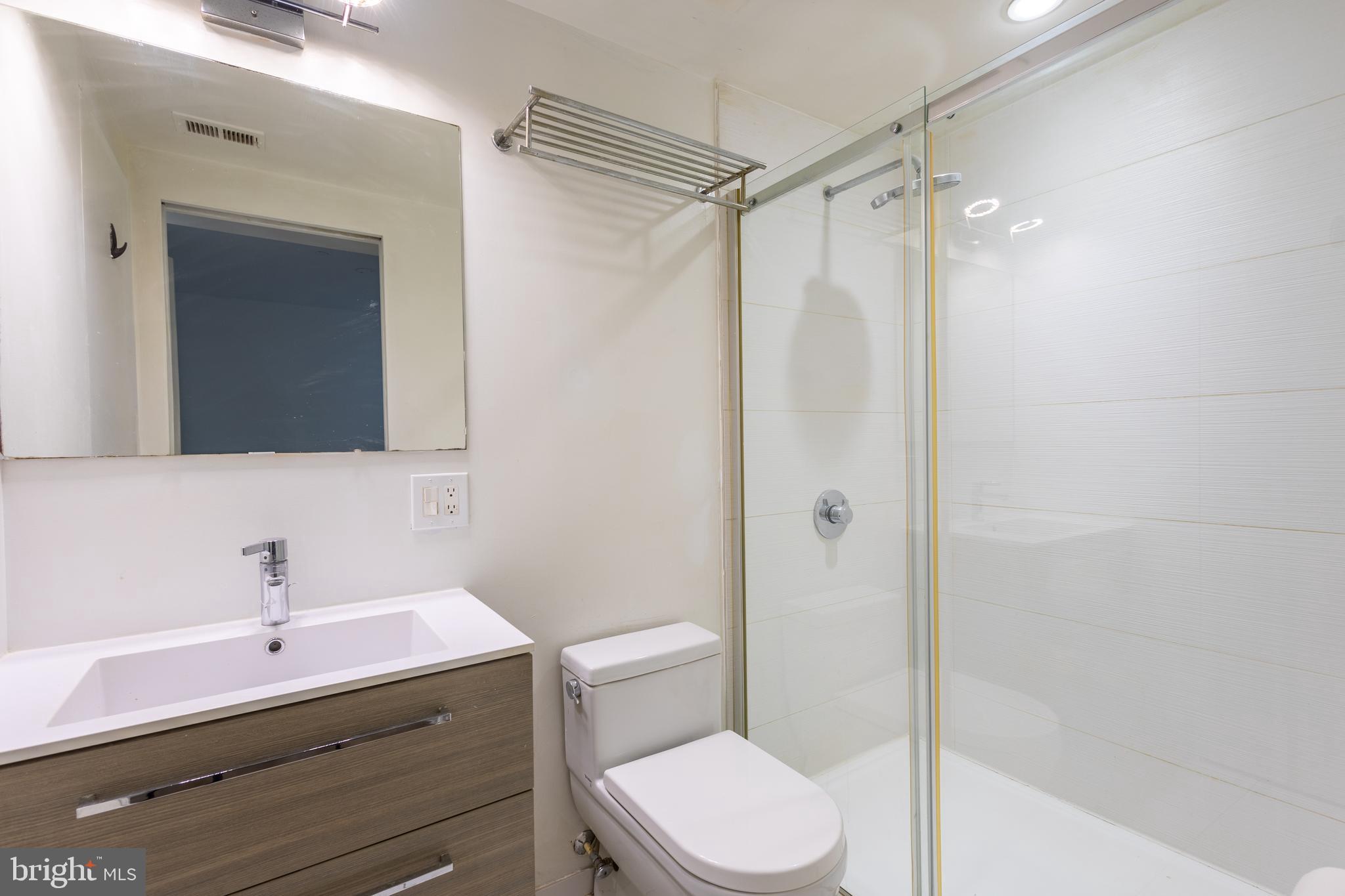 2422-2424 17th Street Northwest, Unit 201 Washington, DC 20009 - Photo 14 of 16 a bathroom with a sink a toilet and shower