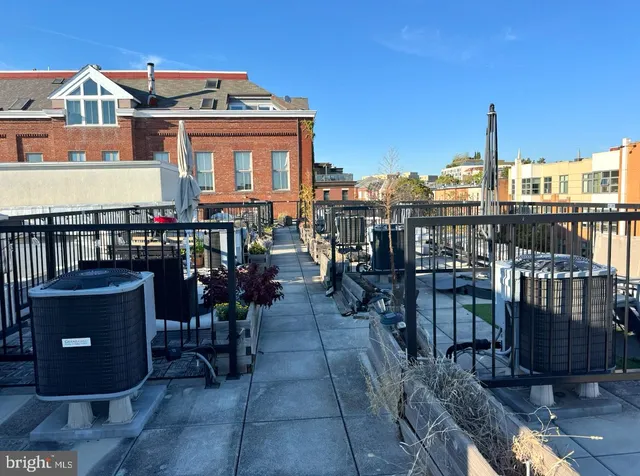 a view of a balcony with chairs potted plants and wooden floor