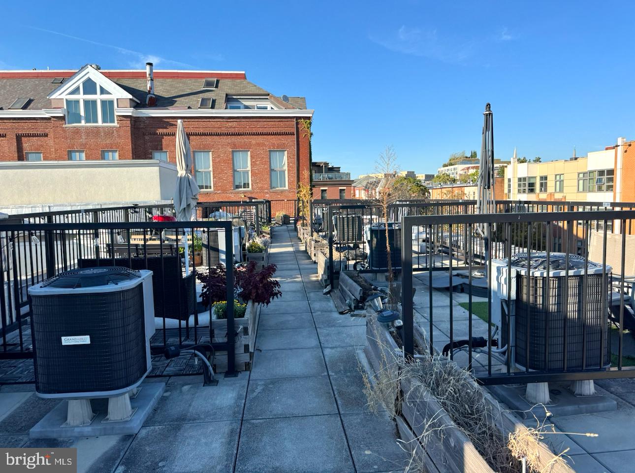 2422-2424 17th Street Northwest, Unit 201 Washington, DC 20009 - Photo 16 of 16 a view of a balcony with chairs potted plants and wooden floor