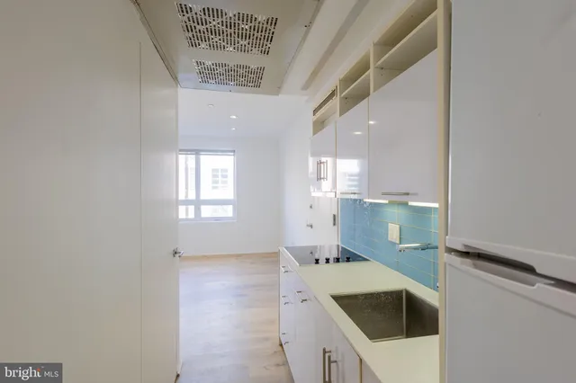 a kitchen with a sink a stove and cabinets
