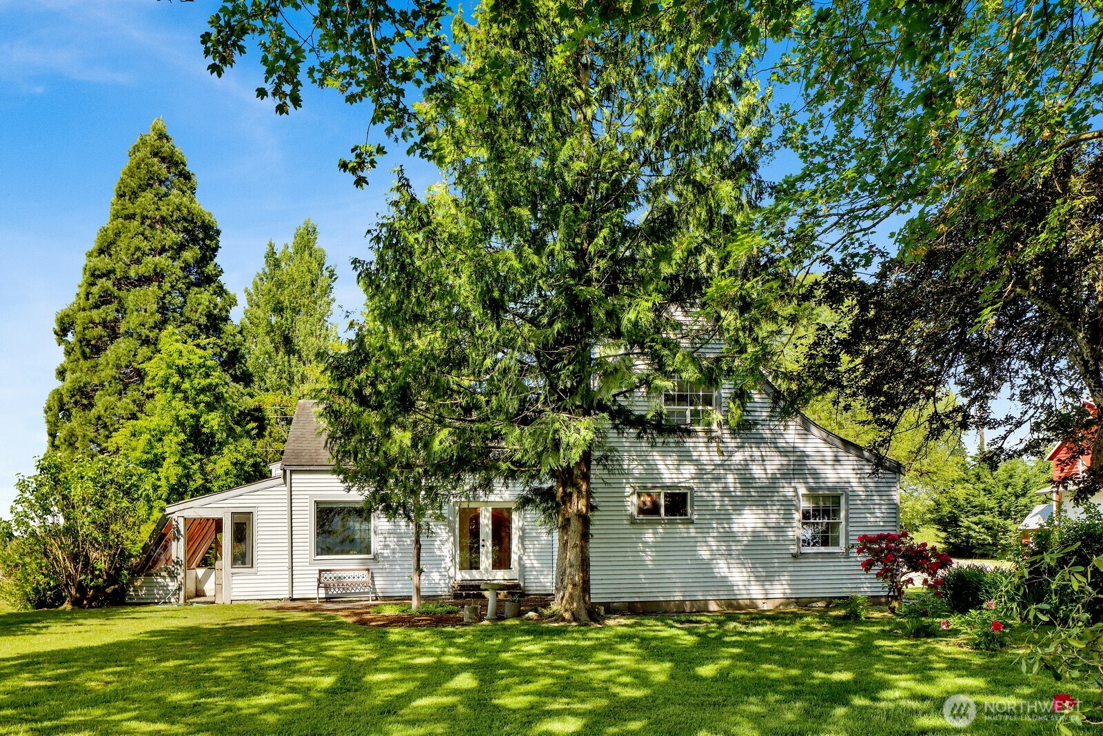 8172 Van Buren Road Everson, WA 98247 - Photo 25 of 33 a backyard of a house with plants and large tree