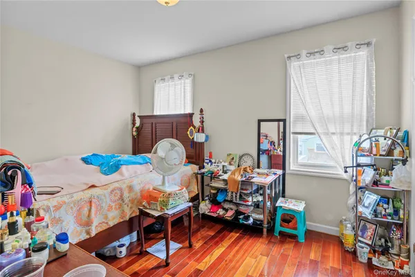 a bedroom with furniture and a wooden floor