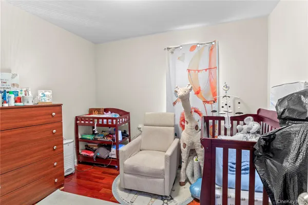 a bedroom with furniture and a baby crib