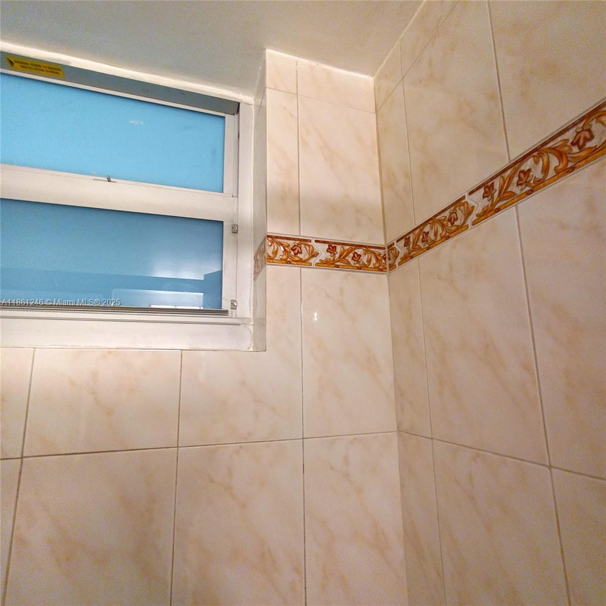8000 Harding Avenue, Unit 3B Miami Beach, FL 33141 - Photo 26 of 30 a bathroom with a window and a shower