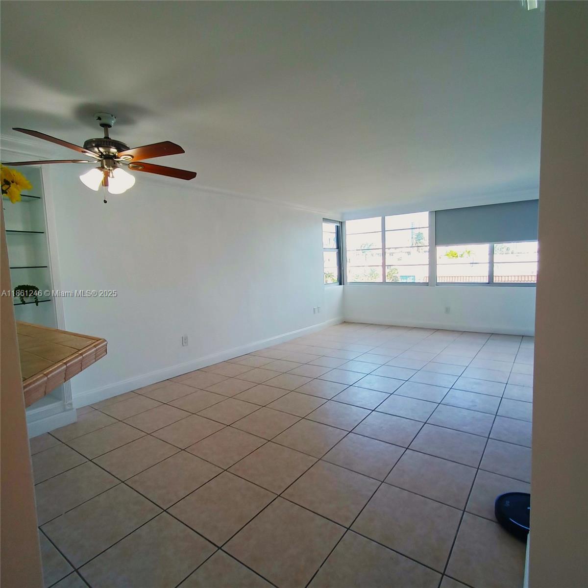 8000 Harding Avenue, Unit 3B Miami Beach, FL 33141 - Photo 29 of 30 en empty room with windows and ceiling fan