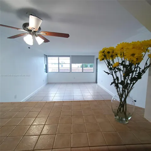 a view of a livingroom with furniture and chandelier fan
