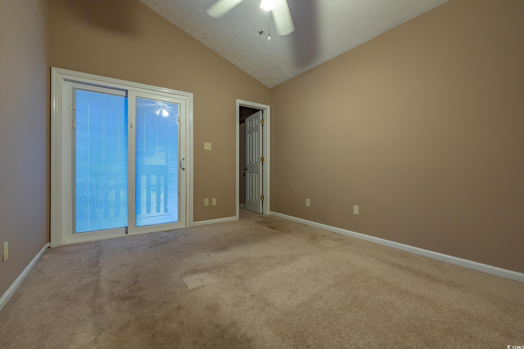 620 15th Avenue South, Unit 89 Surfside Beach, SC 29575 - Photo 14 of 14 Spare room featuring lofted ceiling, light carpet, and ceiling fan