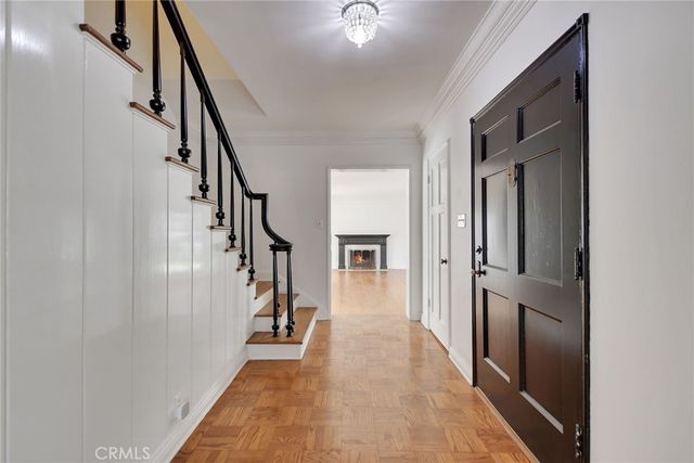 a view of hallway with stairs and wooden floor