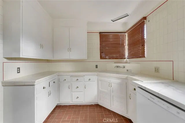 a kitchen with a sink cabinets and window