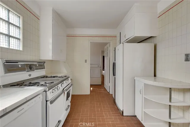 a kitchen with a stove and a refrigerator