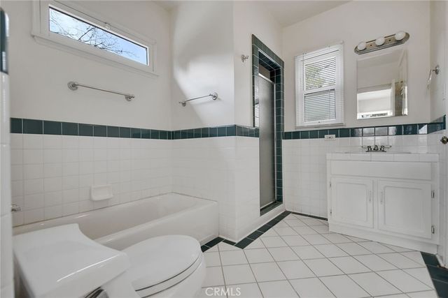 a bathroom with a sink mirror vanity and toilet