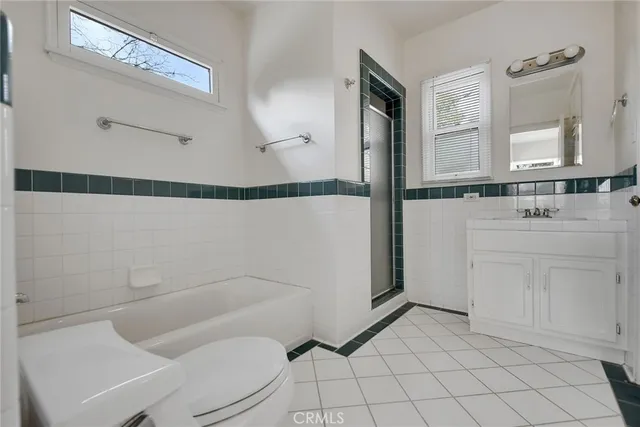 a bathroom with a sink mirror vanity and toilet