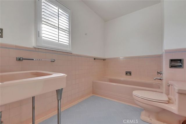 a bathroom with a sink a toilet and bathtub