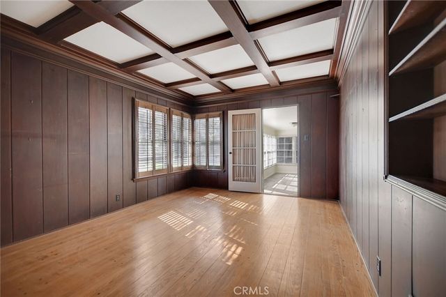 a view of an empty room with a fireplace and a window