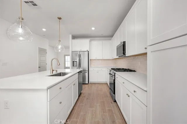a stove top oven sitting inside of a kitchen
