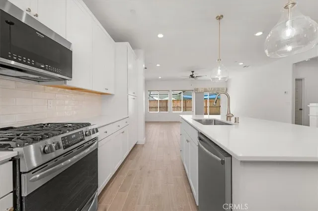 a living room with furniture and large windows