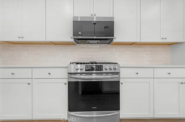 a view of an empty room with a kitchen