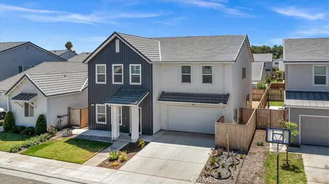 a view of a big room with wooden floor and windows