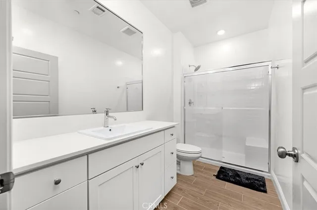 a view of a kitchen with white cabinets