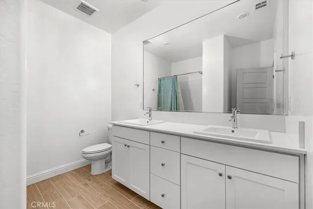 a front view of a house with plants