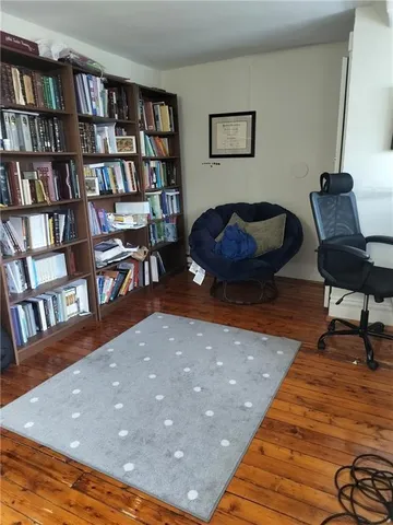 a living room with furniture and a book shelf