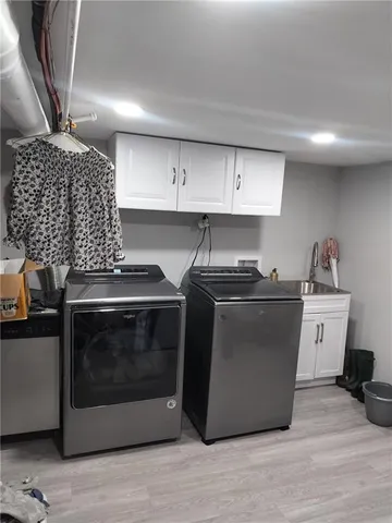 a kitchen with a sink cabinets and stainless steel appliances