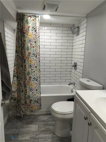 a bathroom with a toilet and a bathtub