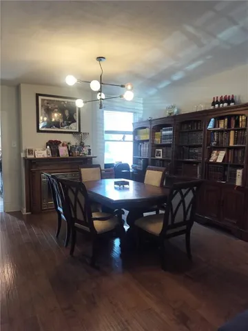 a dining area with furniture and chandelier
