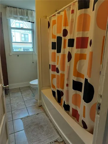 a bathroom with a bathtub and shower