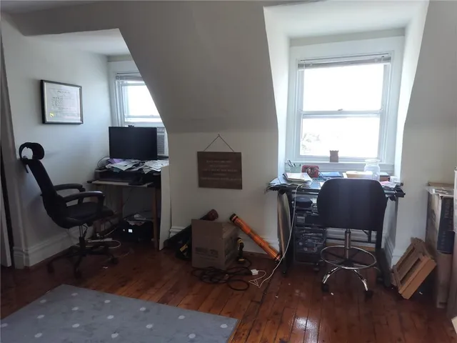 a view of a workspace with furniture and a window