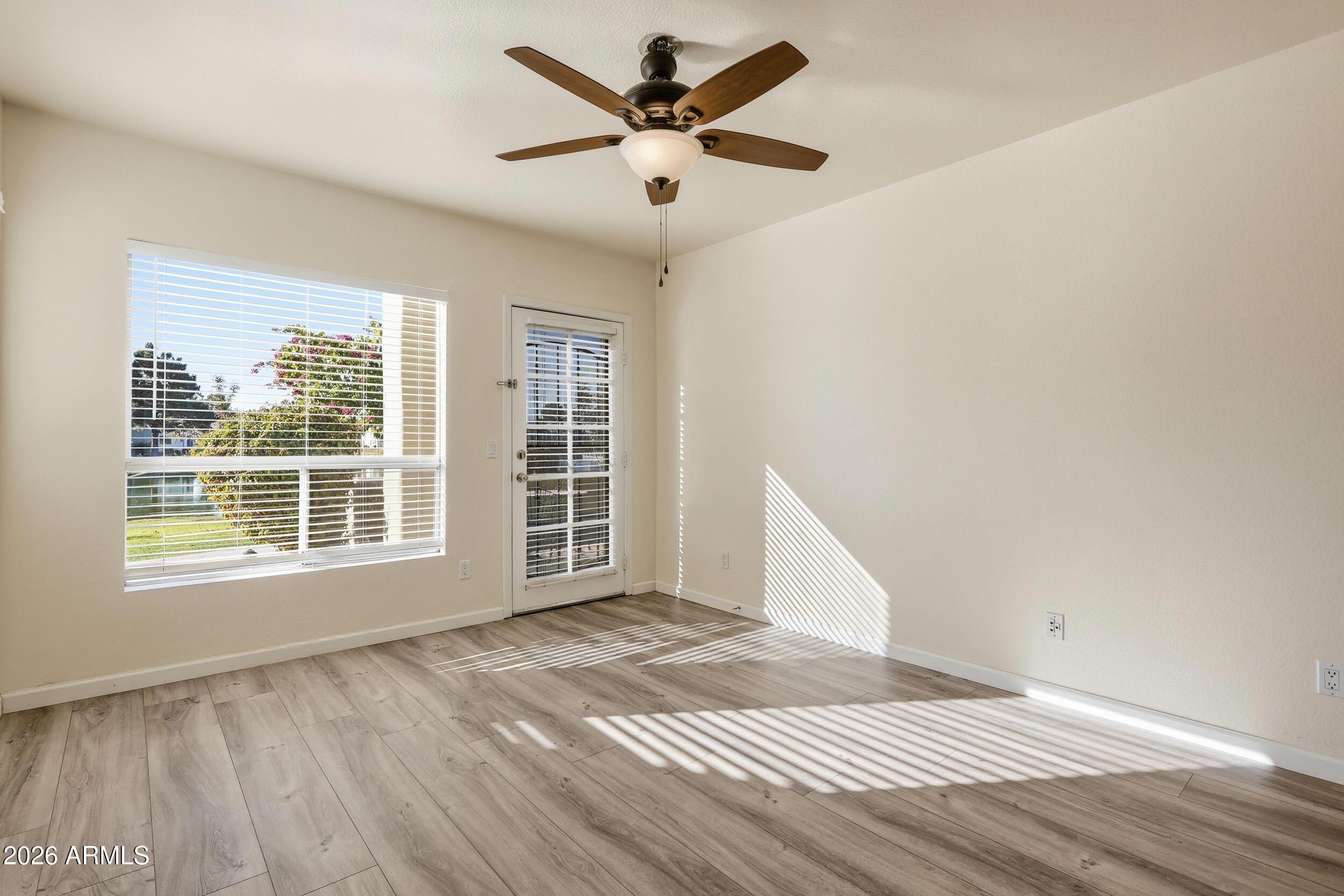 1825 West Ray Road, Unit 1018 Chandler, AZ 85224 - Photo 21 of 46 a view of an empty room with a window and wooden floor